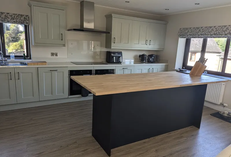 Kitchen island with a dark base and oak worktop